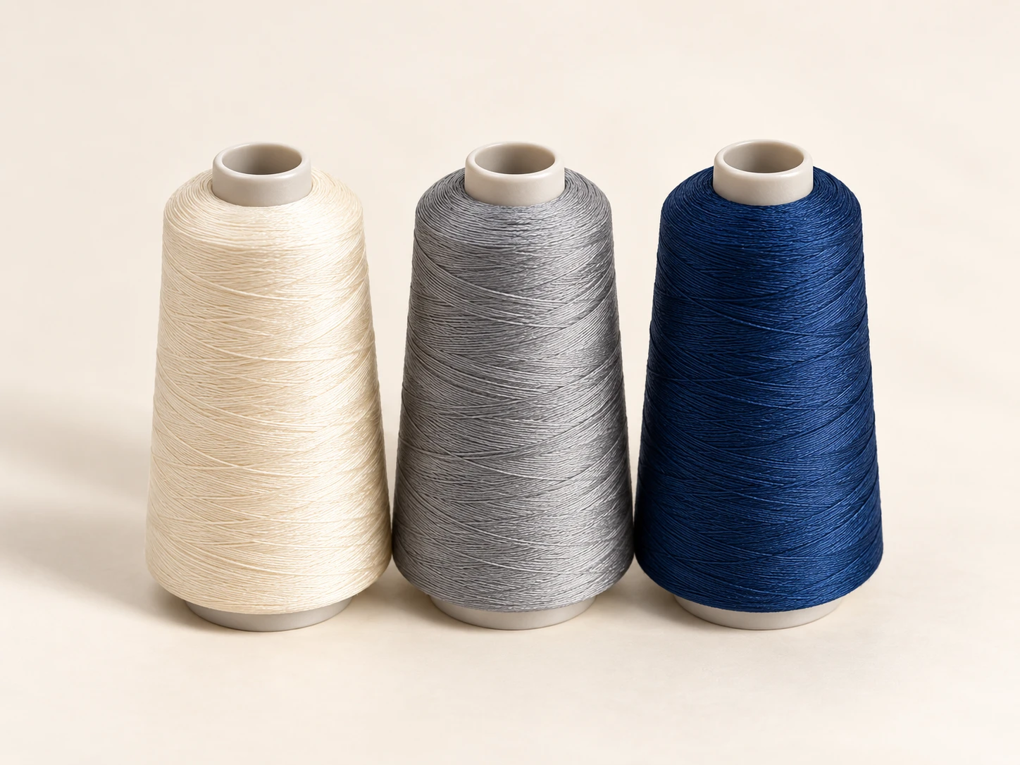 Cream, grey and navy sewing thread cones